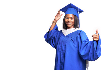 Black woman in a blue robe on a white background smiles and shows thumb up