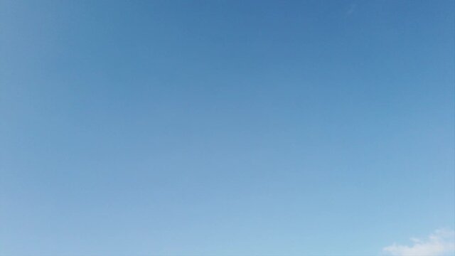 Summertime lapse with blue sky and nice weather with happies white fluffy cirrus floccus clouds speed through the air