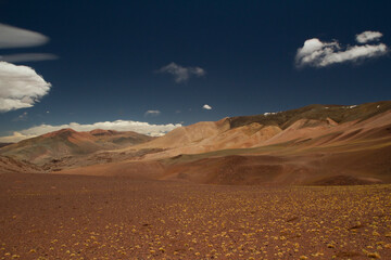 Arid desert landscape high in the Andes mountain range. View of the dunes, brown land and colorful mountains in Laguna Brava, La Rioja, Argentina.