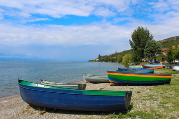 Naklejka na ściany i meble Colorful fishing boats on the lake Ohrid shore. Republic of North Macedonia