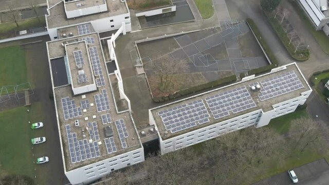 Aerial of solar panels on office building rooftop - crop