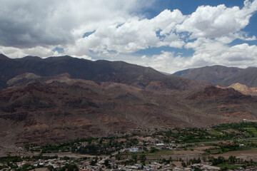 Aerial view of Tilcara village at the foot of Humahuaca ravine in Jujuy, Argentina. The brown Andes mountains and rural town in the altiplano valley. 