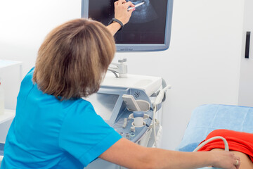 Medical ultrasound scanner close-up. Doctor makes ultrasound diagnosis of belly. Testing pregnant