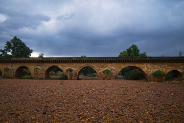 Fototapeta premium roman bridge over a river without water