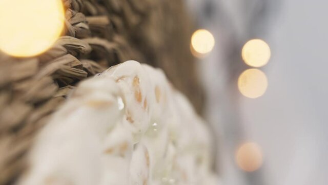 Close up of Turron, typical Christmas sweet in Spain. Almond nougat spinning. Vertical video