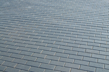 The paving stones on the road are laid in even rows.