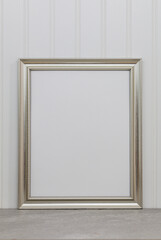 Large silver frame mockup against white wainscot wall for art or copy space