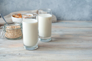 Breakfast with fresh milk on a gray background. Side view with copy space. The concept of natural healthy products.