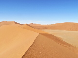 Fototapeta na wymiar Overlooking into desert from Big Daddy sand dune in Sossuvlei Namibia.
