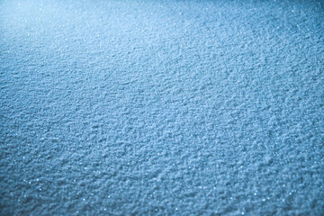 Snow surface texture in blue tone. Winter season background.