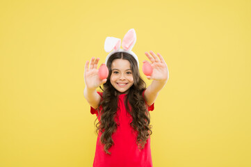 Obraz na płótnie Canvas Cute cheerful bunny schoolgirl celebrate Easter day. Preparing decorations. Funny games. Indoor and outdoor holiday activities. Fun and educational Easter activity for kids. Little girl easter eggs