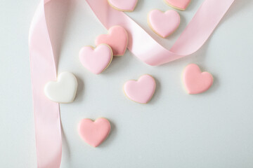 pink heart sugar cookies on white background, with pink ribbon