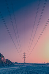power lines in the desert at sunset