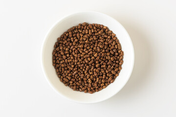 Buckwheat tea in a white bowl on a white background. Top view.