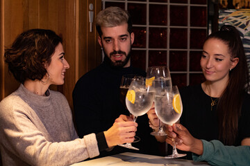 Friends enjoy themselves at a bar while having a drink, the atmosphere is youthful and fun.
