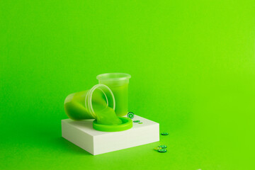 The green slime on green background with plastic fruits
