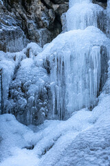 Fototapeta na wymiar freezing waterfalls, forming icicles and the harshest time of the climate