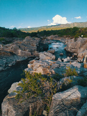 PHOTOGRAPH OF A RIVER AMONG THE ROCKS IN CORDOBA ARGENTINA