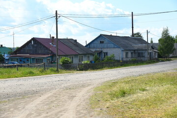 the road to the village with wooden houses