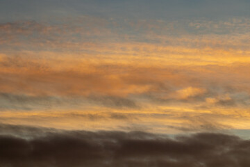 Sunrise with orange sky and colourful clouds