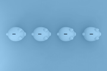Blue pig Banks in a row on colorful background. Concept of saving money. Top view.