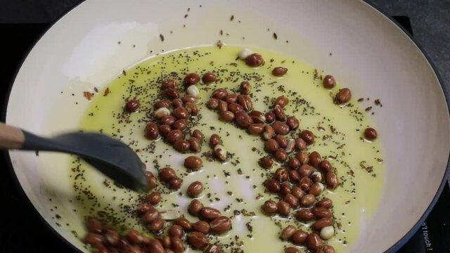 Frying peanuts with Cumin seeds and Mustard seeds