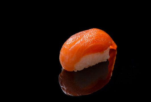 Salmon sushi on black background