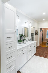 Large white renovated master bathroom with red brick floors