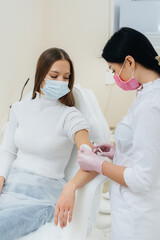 Vaccination of a girl against flu and coronavirus infection during a worldwide pandemic. The formation of the immune system and antibodies.