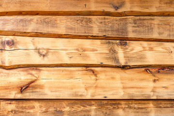 light rough wood uneven edge planks outside wall. Rural flat wooden surface horizontal planks. Texture unpainted natural background. Rustic surface. long, thin pieces of timber. High quality photo