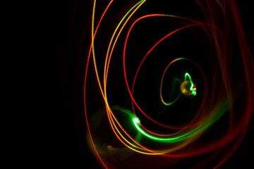 Long exposure colorful lights abstract texture background. Colorful lights drawing patterns on black background. Colored wallpaper.
