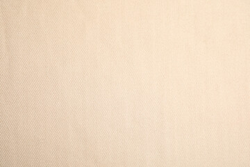 Beige soft cashmere fabric as background, closeup
