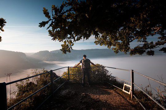 Male explorer with backpack admiring view of Danube Valley at Beuron, Swabian Alb, Germany