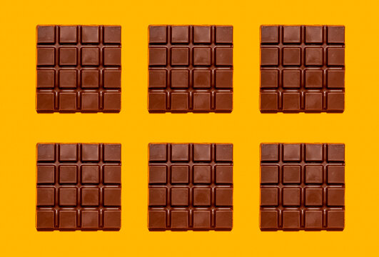 Pattern of chocolate bars against yellow background