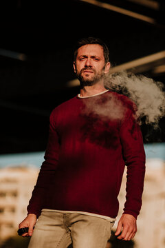 Handsome man portrait in the city smonking electronic cigarette in Rub&radic;&ne; Barcelona Spain
