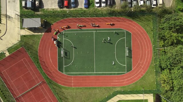 Flight Over The Football Field Top View. Relay Race For Young Children Is Organized On A Football Pier