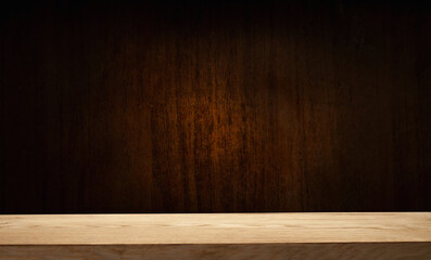Selected focus empty brown wooden table and wall texture or old black brick wall blur background image. For your installation or product demonstration