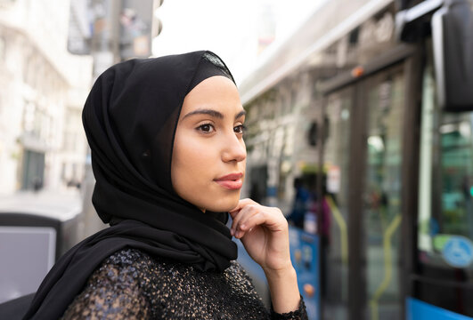Portrait of young beautiful woman wearing black¬†hijab