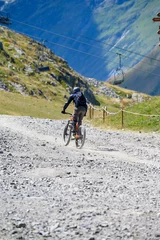 Foto op Aluminium Extreem outdoor sport challenge in French Alps mountains in summer, riding downhill on sport bike on special bicycle path © barmalini
