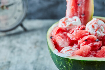Ice-cream inside of juicy watermelon and clock