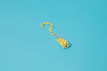 Valerian sedative pills in question shape on blue background