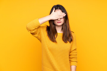 Young caucasian woman isolated on yellow background covering eyes by hands. Do not want to see...