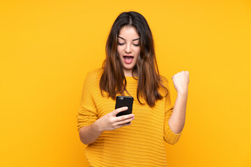 Fototapeta premium Young caucasian woman isolated on yellow background surprised and sending a message