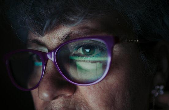 Close-up of senior woman wearing eyeglasses working at home
