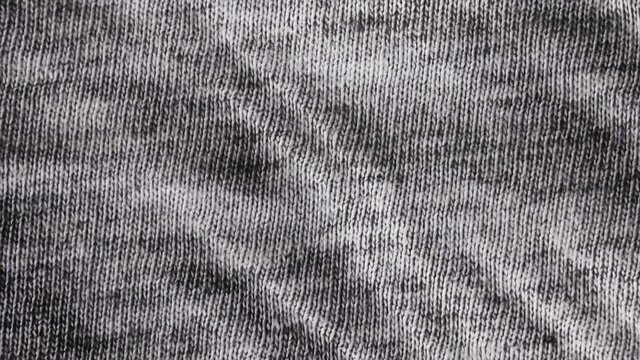 Black and white burlap texture background macro shot. Detailed grey fabric cloth background with pan movement.