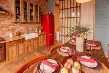 cozy all wooden interior of a country house in a wooden design. spacious living room with kitchen area with large windows. bedroom on the second floor.