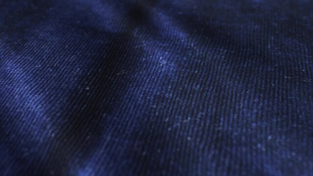 Dark blue velvet surface background. Detailed macro shoot of velveteen velour.