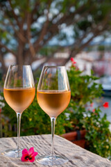 Tasting of local rose wine in summer with sail boats haven of Port Grimaud on background, Provence, France