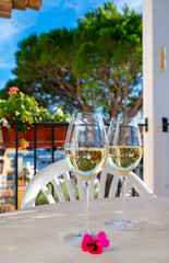 Tasting of local white wine on sunny summer balcony Provence, France