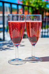 Summer party with sparkling rose champagne wine and sail boats haven of Port Grimaud on background, Provence, France